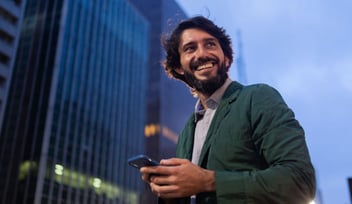 smiling man holding smartphone