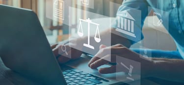 Male hands type on laptop computer in the background. In the foreground, are transparent representations of include scales, a magnifying glass, a gavel and a Greek temple.
