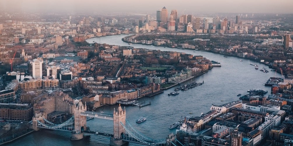 Aerial view of London and the Thames river with London Bridge in the foreground and the central business district, "the City", in the background.